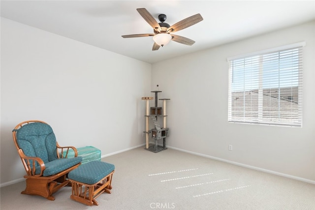 sitting room featuring carpet flooring, a ceiling fan, and baseboards