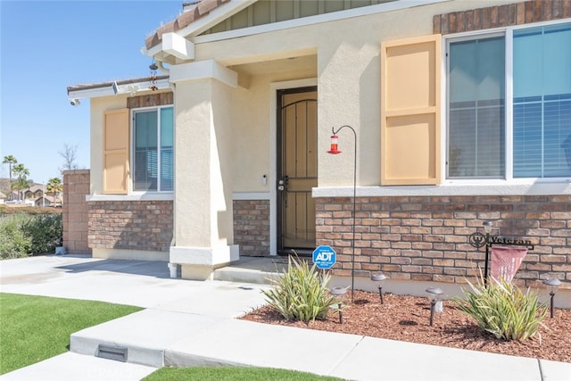 entrance to property featuring board and batten siding and stucco siding