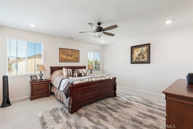 bedroom with light carpet, visible vents, recessed lighting, and baseboards