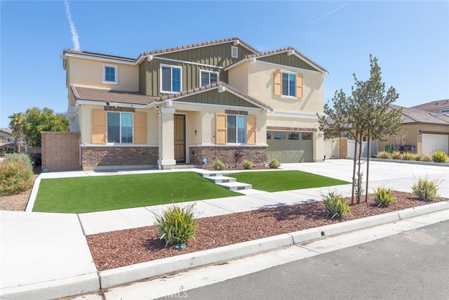 craftsman inspired home featuring brick siding, concrete driveway, a front lawn, and fence