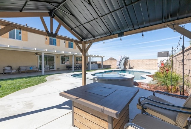 view of patio / terrace featuring a fenced backyard and a pool with connected hot tub