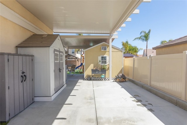 view of patio with a fenced backyard, a storage shed, and an outdoor structure