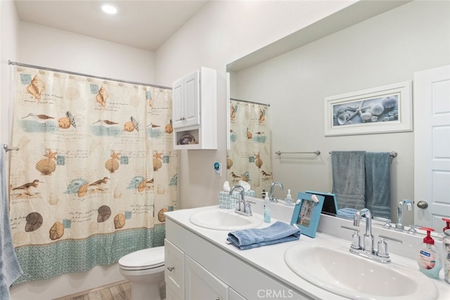 bathroom with double vanity, toilet, shower / bath combo with shower curtain, and a sink