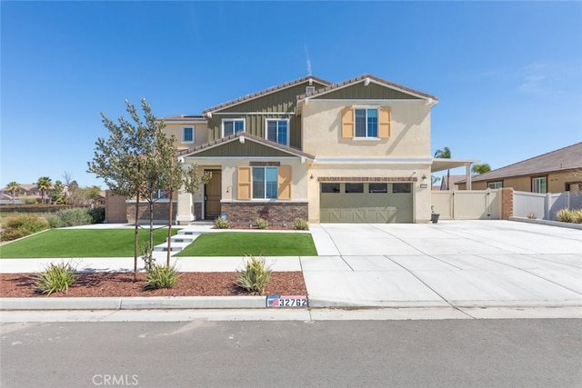 craftsman inspired home with fence, concrete driveway, an attached garage, a front yard, and brick siding