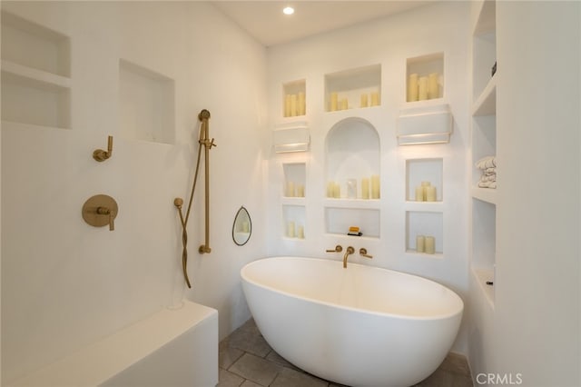 bathroom with tile patterned flooring, a soaking tub, and recessed lighting