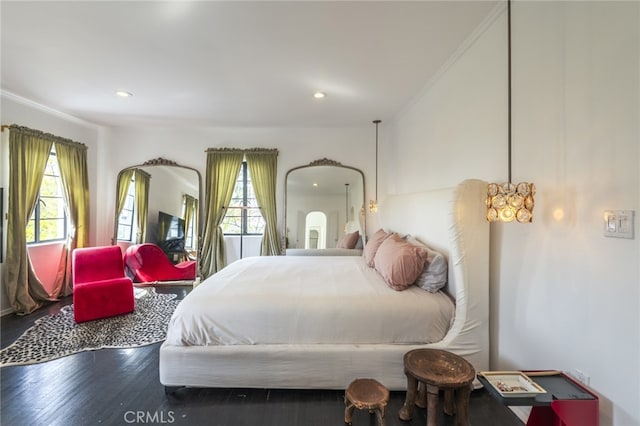 bedroom with recessed lighting and wood finished floors