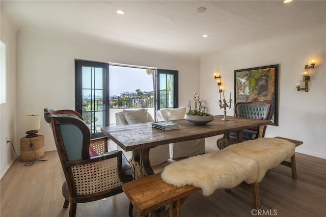 dining space featuring recessed lighting, baseboards, and wood finished floors