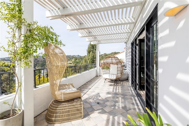 balcony featuring a pergola