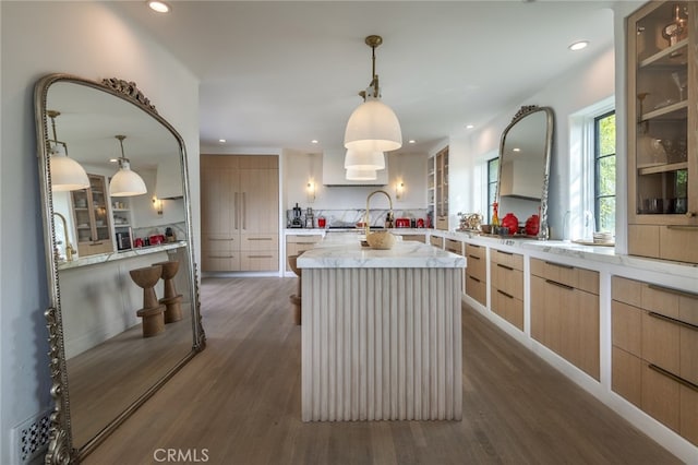 kitchen with dark wood finished floors, light brown cabinets, modern cabinets, and a center island