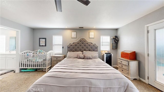 carpeted bedroom with visible vents, baseboards, and ceiling fan