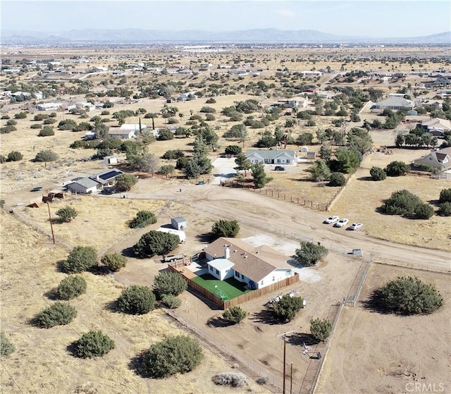 aerial view featuring a mountain view and view of desert