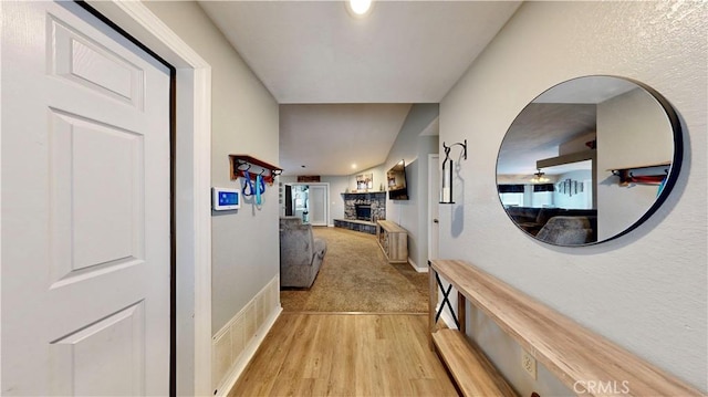 hall with baseboards and light wood-type flooring