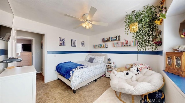 bedroom featuring light colored carpet and a ceiling fan