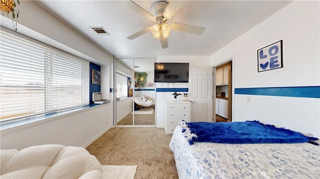 bedroom with carpet flooring, a ceiling fan, visible vents, and baseboards