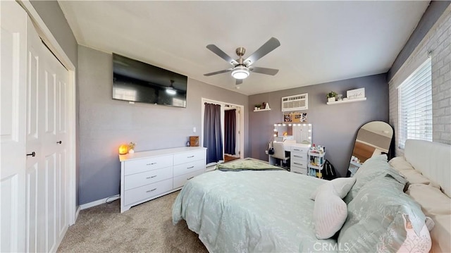 bedroom featuring a closet, light carpet, baseboards, and ceiling fan