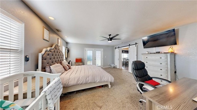 bedroom with visible vents, a barn door, carpet floors, french doors, and access to exterior