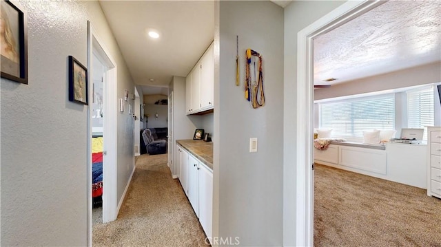 hallway with light colored carpet