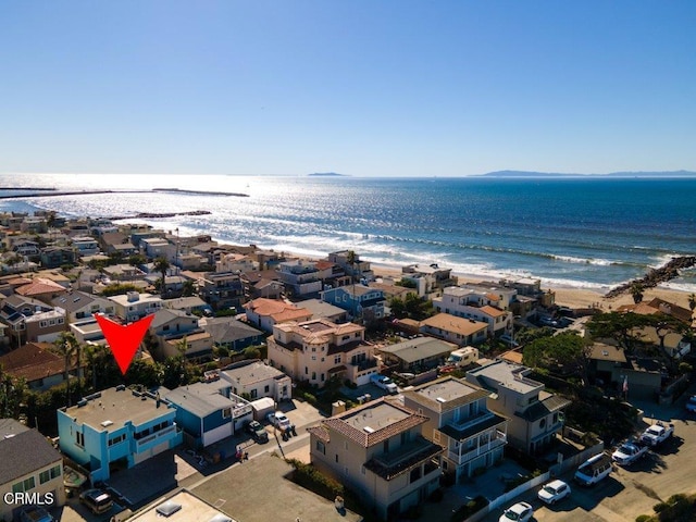 drone / aerial view with a view of the beach, a water view, and a residential view