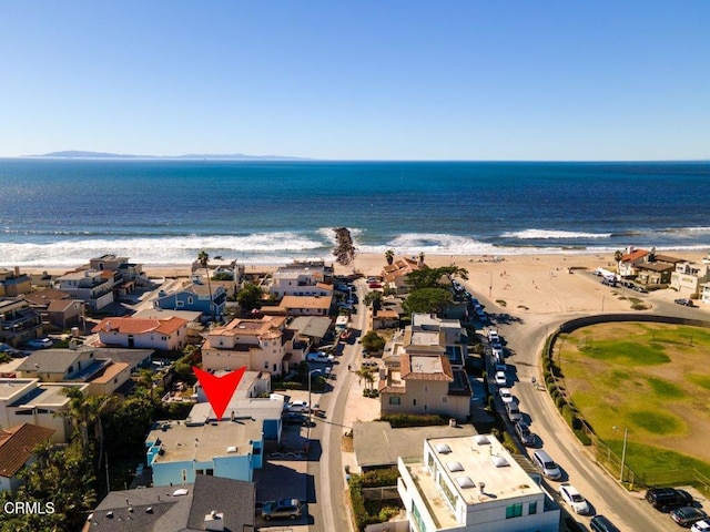 aerial view with a residential view, a water view, and a beach view