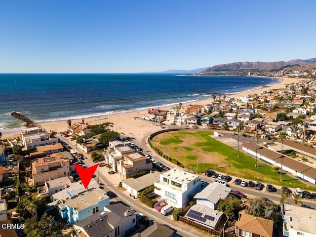 aerial view with a residential view, a view of the beach, and a water view