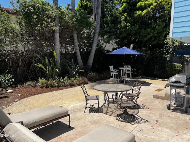 view of patio featuring area for grilling and outdoor dining area