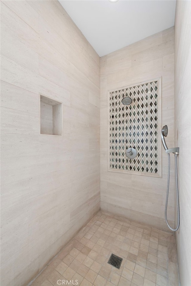 full bath with a tile shower