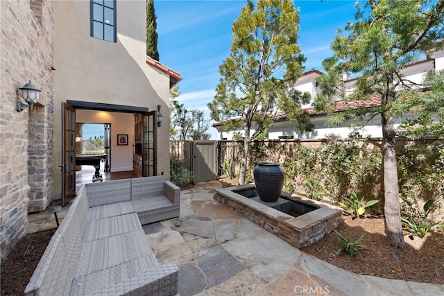 view of patio / terrace featuring a gate, an outdoor living space, and fence