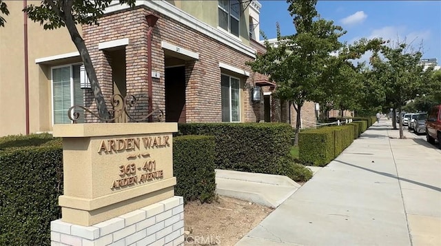 view of home's exterior with stucco siding and brick siding