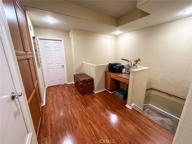 office area with wood finished floors, baseboards, and a textured ceiling