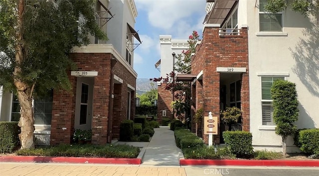 view of home's exterior featuring stucco siding and brick siding