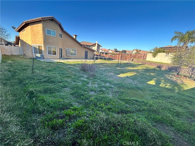 view of yard with cooling unit and a fenced backyard