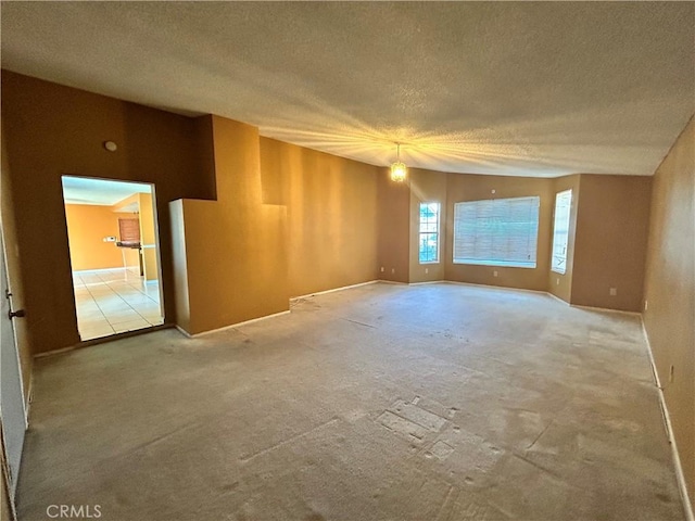 unfurnished room with carpet floors and a textured ceiling