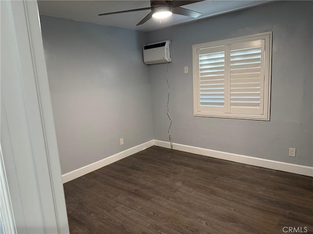 unfurnished room featuring a wall unit AC, a ceiling fan, baseboards, and dark wood-style flooring