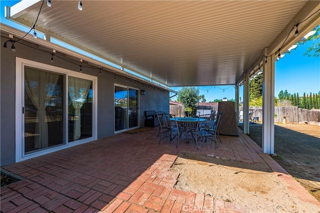 view of patio / terrace with outdoor dining area and fence