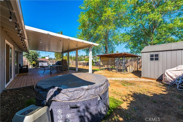 view of yard featuring a patio area, a storage shed, and an outdoor structure