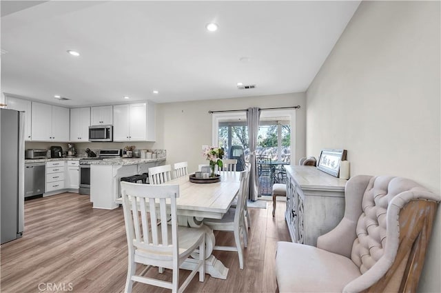 dining room with a toaster, visible vents, recessed lighting, and light wood-type flooring