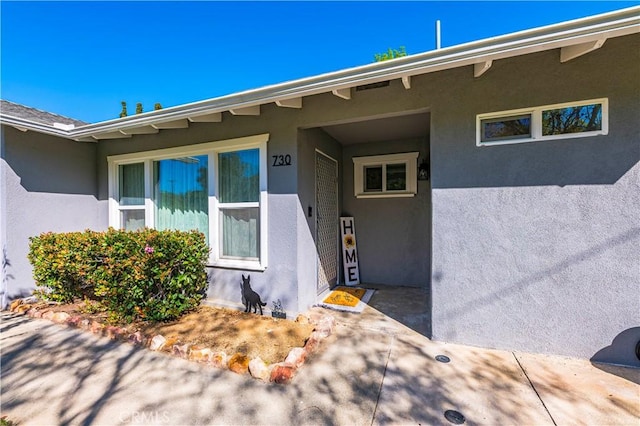 property entrance featuring stucco siding