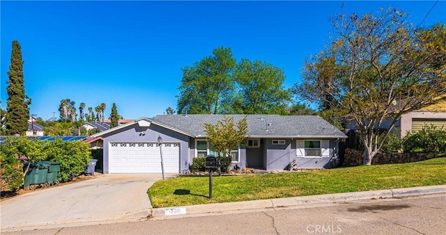 ranch-style home featuring stucco siding, driveway, an attached garage, and a front lawn