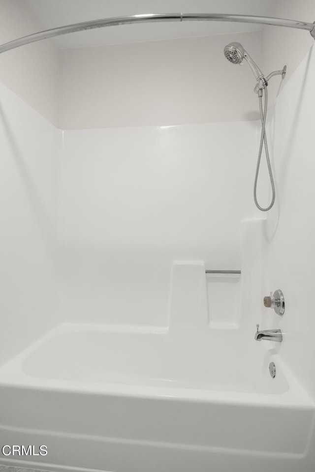 bathroom with bathing tub / shower combination