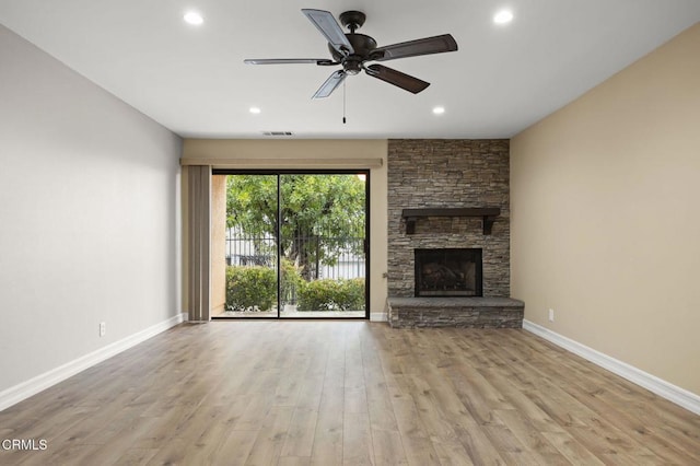 unfurnished living room with a ceiling fan, wood finished floors, recessed lighting, a fireplace, and baseboards