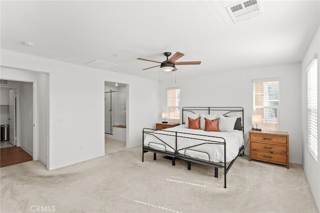 carpeted bedroom with visible vents and ceiling fan