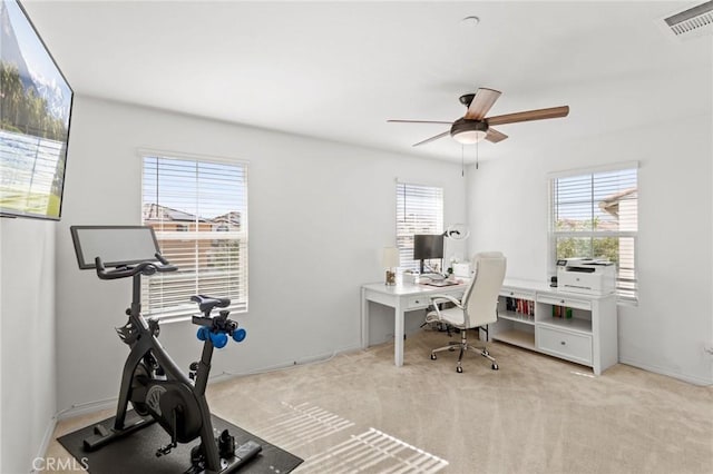 office with visible vents, carpet flooring, and a ceiling fan