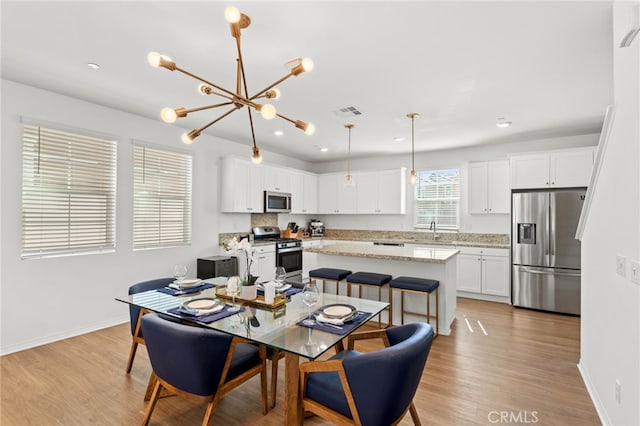 dining space featuring visible vents, recessed lighting, light wood-style floors, baseboards, and a chandelier