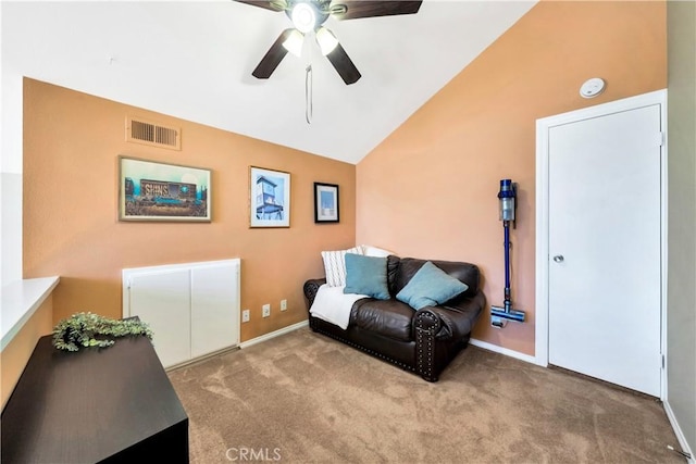 sitting room with visible vents, carpet floors, baseboards, ceiling fan, and vaulted ceiling