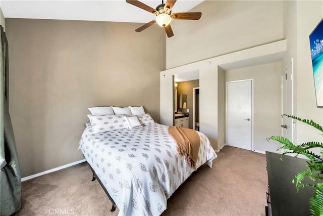 bedroom with baseboards, a ceiling fan, a towering ceiling, and carpet floors