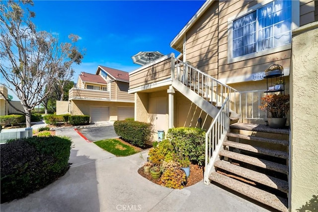 view of building exterior with stairs and a garage