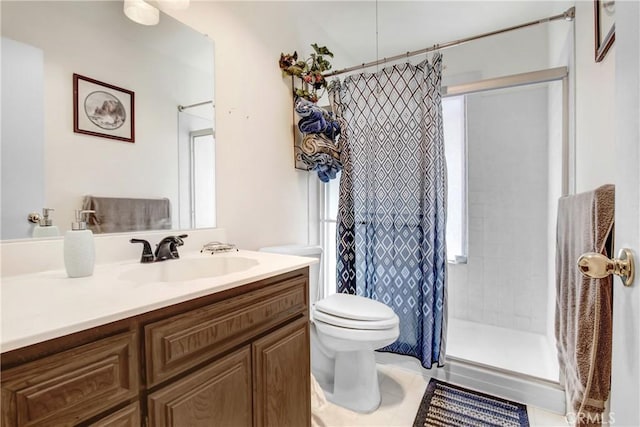 bathroom with tile patterned flooring, a stall shower, toilet, and vanity