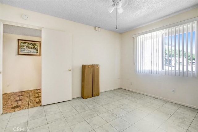 unfurnished room featuring a textured ceiling