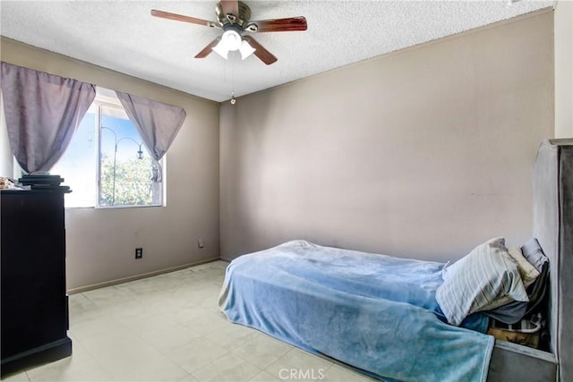 bedroom with baseboards, a textured ceiling, and ceiling fan