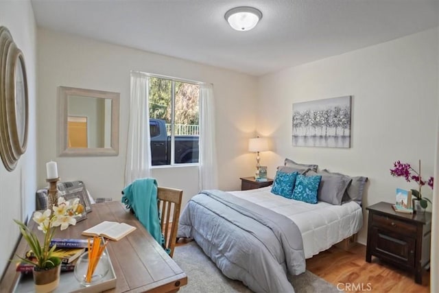 bedroom featuring freestanding refrigerator